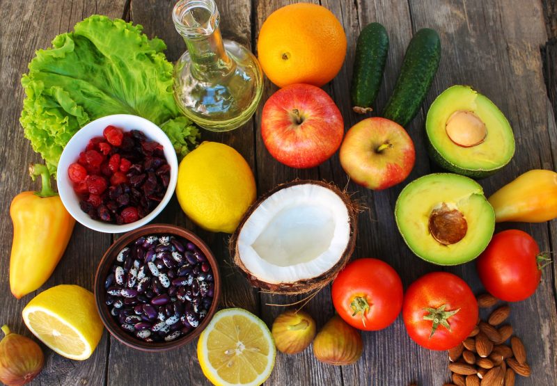 Healthy food of vegetable origin on old wooden background. Concept of proper nutrition. Top view.